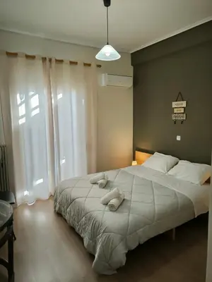 a bedroom with a large bed with two towels on it at Group & family penthouse 300m from Agios Ioannis subway,metro station! in Athens
