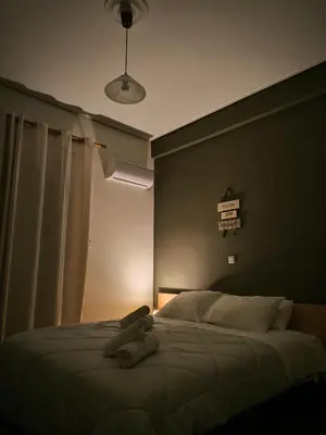 a teddy bear laying on a bed in a bedroom at Group & family penthouse 300m from Agios Ioannis subway,metro station! in Athens