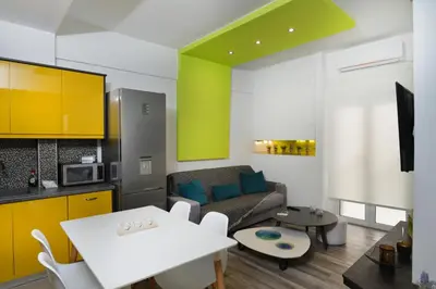 a living room with a couch and a table at Colorful Apt. Near Nea Smirni Square in Athens