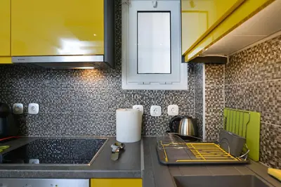 a kitchen with a sink and a counter top at Colorful Apt. Near Nea Smirni Square in Athens