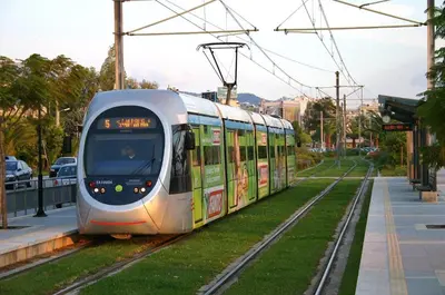a train on the tracks in a city at Colorful Apt. Near Nea Smirni Square in Athens