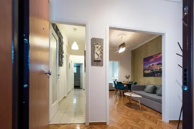 a hallway leading to a living room with a couch at Blue Ark Acropolis Spirit in Athens