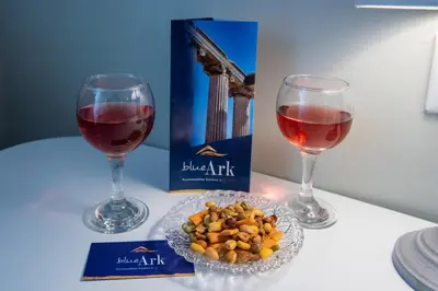 two glasses of red wine and a bowl of nuts at Blue Ark Acropolis Spirit in Athens