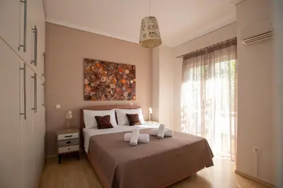 a bedroom with a bed and a painting on the wall at Blue Ark Acropolis Spirit in Athens