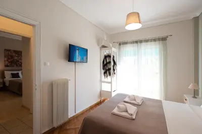 a bedroom with a bed with two towels on it at Blue Ark Acropolis Spirit in Athens