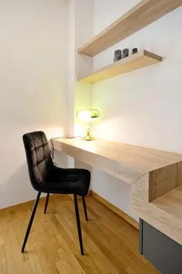 a black chair sitting next to a desk with a lamp at Elegant Big Apartment in Athens Center With Balcony in Athens