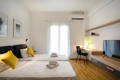 a bedroom with two beds and a flat screen tv at Elegant Big Apartment in Athens Center With Balcony in Athens
