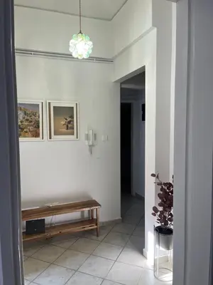 a hallway with a bench in a white room at Alex’s home next to Laiko in Athens