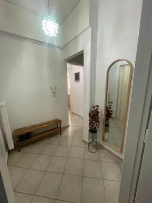 a hallway with a mirror and a bench in a room at Alex’s home next to Laiko in Athens