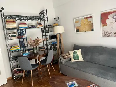 a living room with a couch and a table at Alex’s home next to Laiko in Athens