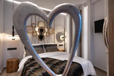 a bedroom with a bed with a heart shaped frame at Olympiou at Heart of Koukaki in Athens