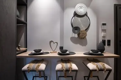 a dressing table with two stools and a mirror at Olympiou at Heart of Koukaki in Athens