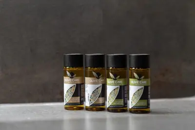 three bottles of mustard sitting on a table at Olympiou at Heart of Koukaki in Athens
