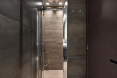 a shower with a glass door in a bathroom at Olympiou at Heart of Koukaki in Athens