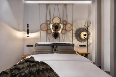 a bedroom with a bed with hats on the wall at Olympiou at Heart of Koukaki in Athens