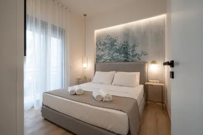 a bedroom with a bed with two towels on it at IO SUITES in Athens