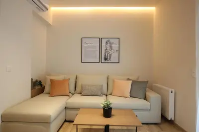a living room with a couch and a table at IO SUITES in Athens
