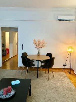 a living room with a table and chairs at Cozy apartment in Kolonaki Athens - Sleeps 5 in Athens