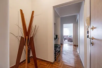a room with a hallway with wooden floors and a door at Cozy apartment in Kolonaki Athens - Sleeps 5 in Athens