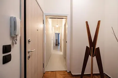 a hallway leading to a room with a door and a television at Cozy apartment in Kolonaki Athens - Sleeps 5 in Athens