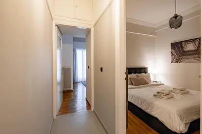 a small bedroom with a bed and a hallway at Cozy apartment in Kolonaki Athens - Sleeps 5 in Athens