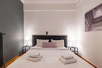 a bedroom with a large white bed with towels on it at Cozy apartment in Kolonaki Athens - Sleeps 5 in Athens