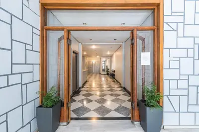 a hallway with two potted plants in a building at Rest Sleep Repeat by museum-1 in Athens