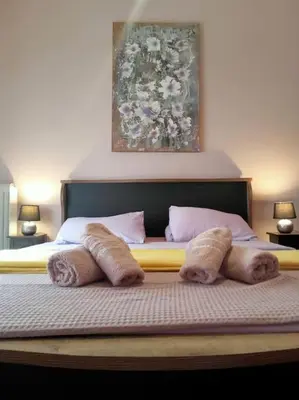 a bed with four pillows on top of it at Urban comfort apartment. in Athens