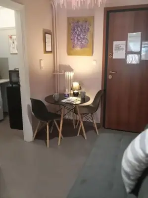a room with a table and chairs and a door at Urban comfort apartment. in Athens