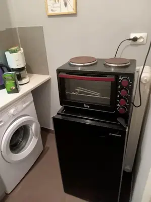 a kitchen with a microwave and a washing machine at Urban comfort apartment. in Athens
