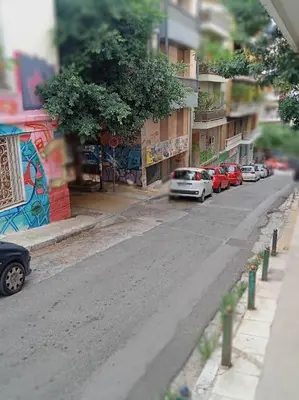 a street with cars parked on the side of a building at Urban comfort apartment. in Athens