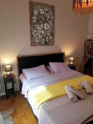 a bedroom with a bed with two slippers on it at Urban comfort apartment. in Athens