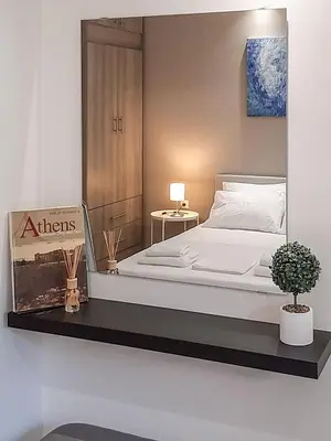 a bedroom with a bed with a sign on it at Byronico Acropolis Apartment by MPS in Athens