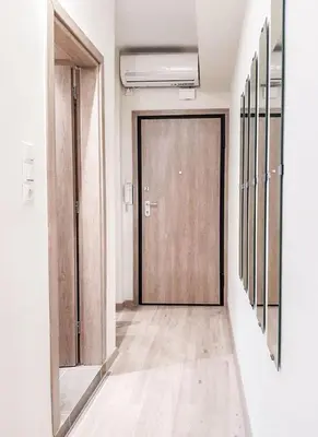 a hallway with a wooden door in a room at Byronico Acropolis Apartment by MPS in Athens