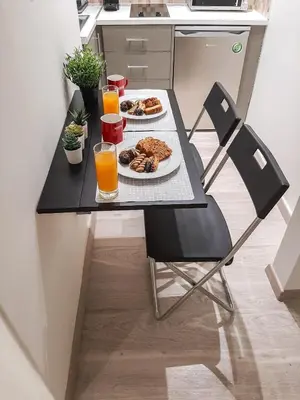 a table with two plates of food and two glasses of orange juice at Byronico Acropolis Apartment by MPS in Athens