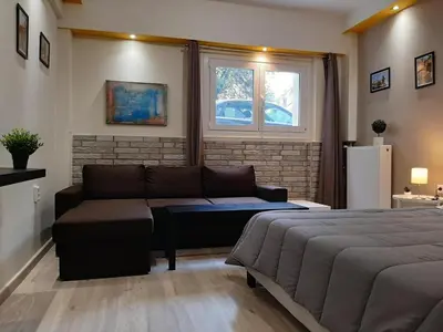 a living room with a bed and a couch at Byronico Acropolis Apartment by MPS in Athens