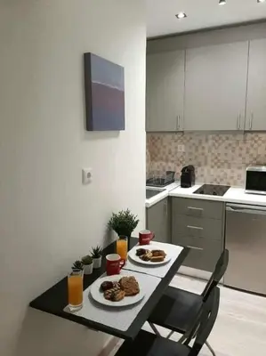 a kitchen with a table with two plates of food on it at Byronico Acropolis Apartment by MPS in Athens
