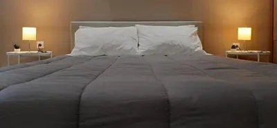 a large bed with white pillows in a bedroom at Byronico Acropolis Apartment by MPS in Athens