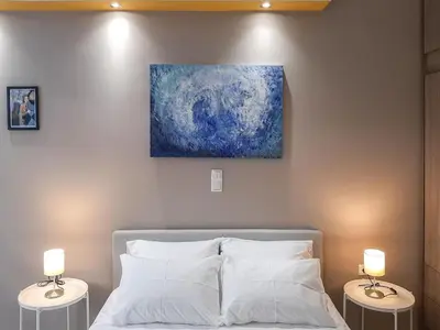a bedroom with a bed with two lamps on tables at Byronico Acropolis Apartment by MPS in Athens