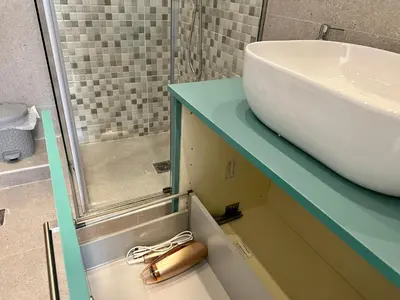 a bathroom with a sink and a glass counter at A13 Athens in Athens