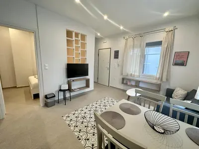 a living room with a couch and a table and a tv at A13 Athens in Athens