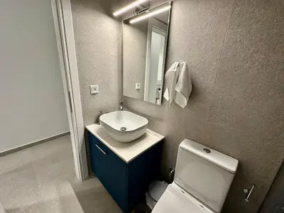 a bathroom with a sink and a toilet and a mirror at A13 Athens in Athens