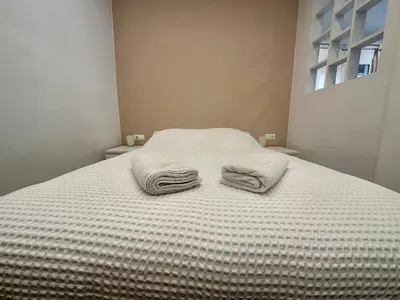 a bed with two towels sitting on top of it at A13 Athens in Athens