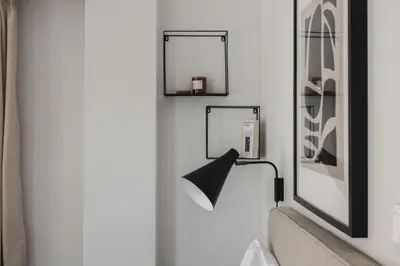 a bathroom with two mirrors and a lamp on the wall at Remarkable 2BR Apartment in Paleo Faliro by UPSTREET in Athens