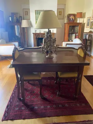 a table with a lamp on top of a rug at Traditional And Spacious Apartment In Neo Psychiko in Athens