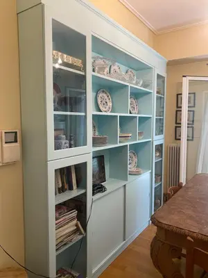 a built in book shelf in a dining room at Traditional And Spacious Apartment In Neo Psychiko in Athens