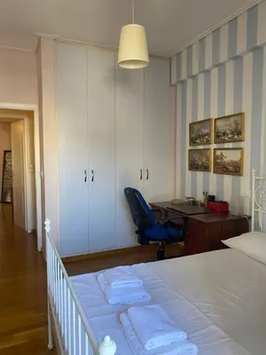 a bedroom with a bed and a desk and a chair at Traditional And Spacious Apartment In Neo Psychiko in Athens