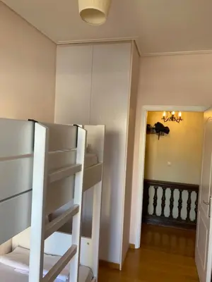 a room with two bunk beds and a hallway at Traditional And Spacious Apartment In Neo Psychiko in Athens