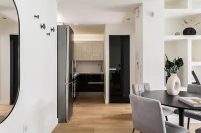 a dining room and kitchen with a table and chairs at Striking Apartments in Kolonaki by UPSTREET in Athens