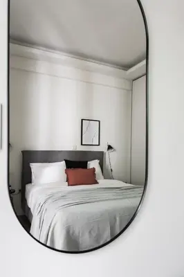 a mirror reflection of a bed in a bedroom at Striking Apartments in Kolonaki by UPSTREET in Athens